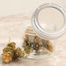 Small clear glass jar with 5x magnifying lid for weed storage